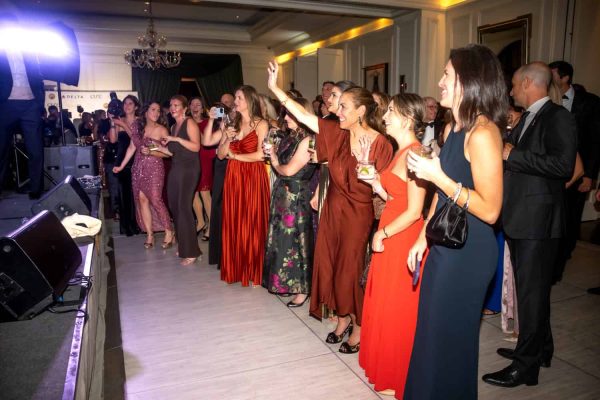 Guests dancing and enjoying the Believe Ball event in an elegant venue.