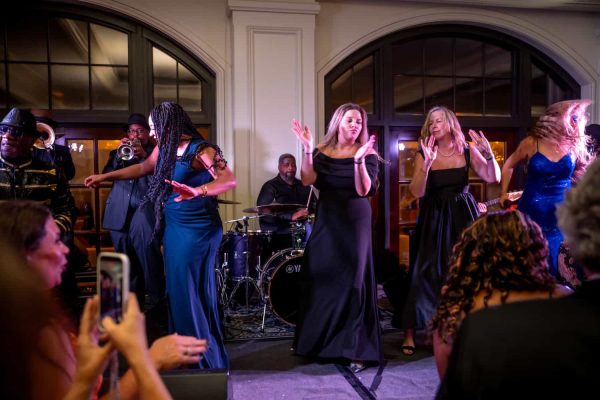 Live musical performance at Believe Ball event with dancers and band.