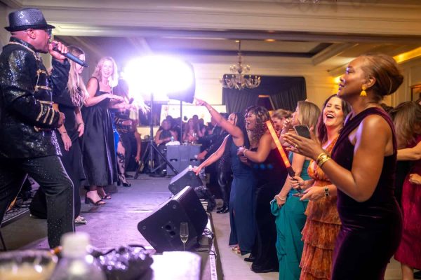 People enjoying live music and dancing at Believe Ball event.