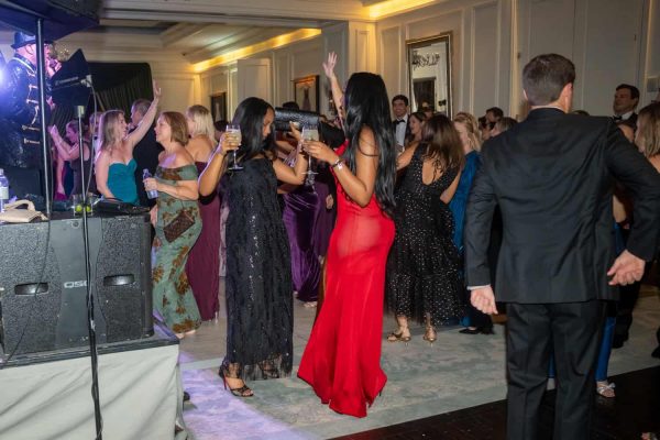 People dancing and enjoying the Believe Ball event in an elegant venue.