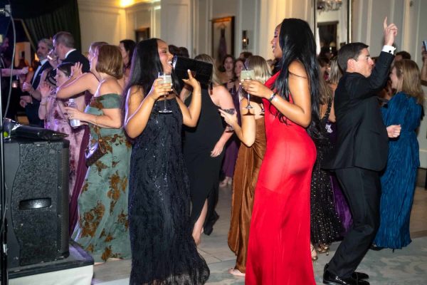 People dancing and socializing at the Believe Ball event in an elegant venue.