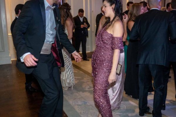 People dancing at the Believe Ball charity event in an elegant ballroom.