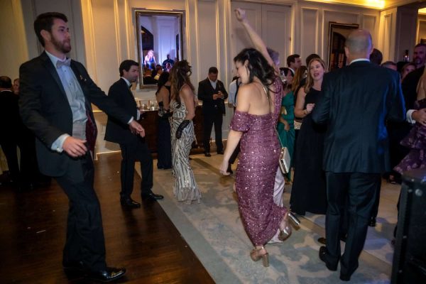 People dancing and enjoying at the Believe Ball event in an elegant venue.