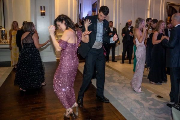 People dancing at the Believe Ball charity event in an elegant ballroom.