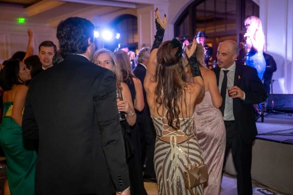 People dancing and socializing at the Believe Ball event in an elegant venue.