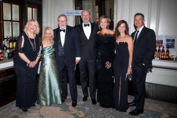 Group of people in formal attire at Believe Ball event in 2026.