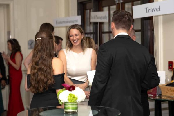 People networking at the Believe Ball event in an elegant setting.