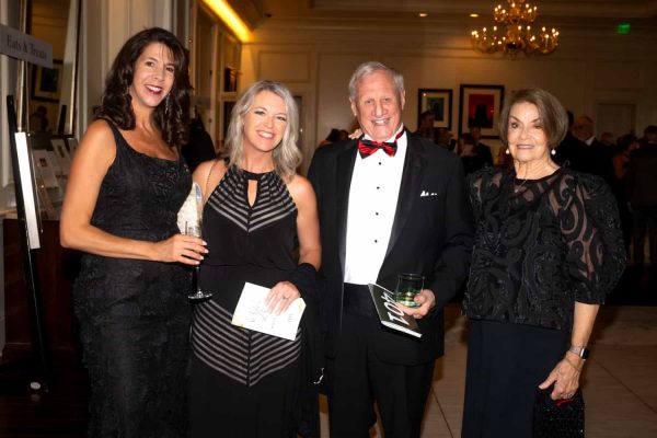 Group of four elegantly dressed people at Believe Ball event in 2026.