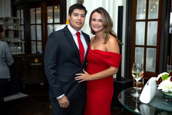 Young man and woman in formal attire at Believe Ball event.